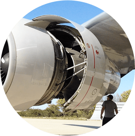 Aircraft mechanic looking at a Boeing 757 engine